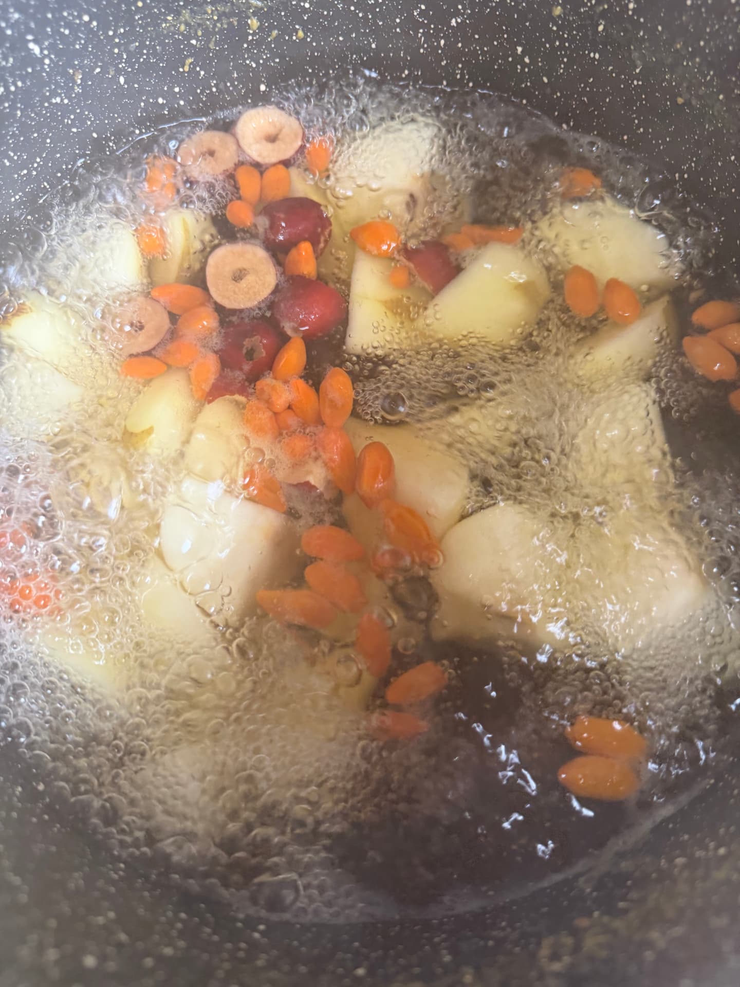 Apple, red date and goji berry soup simmering