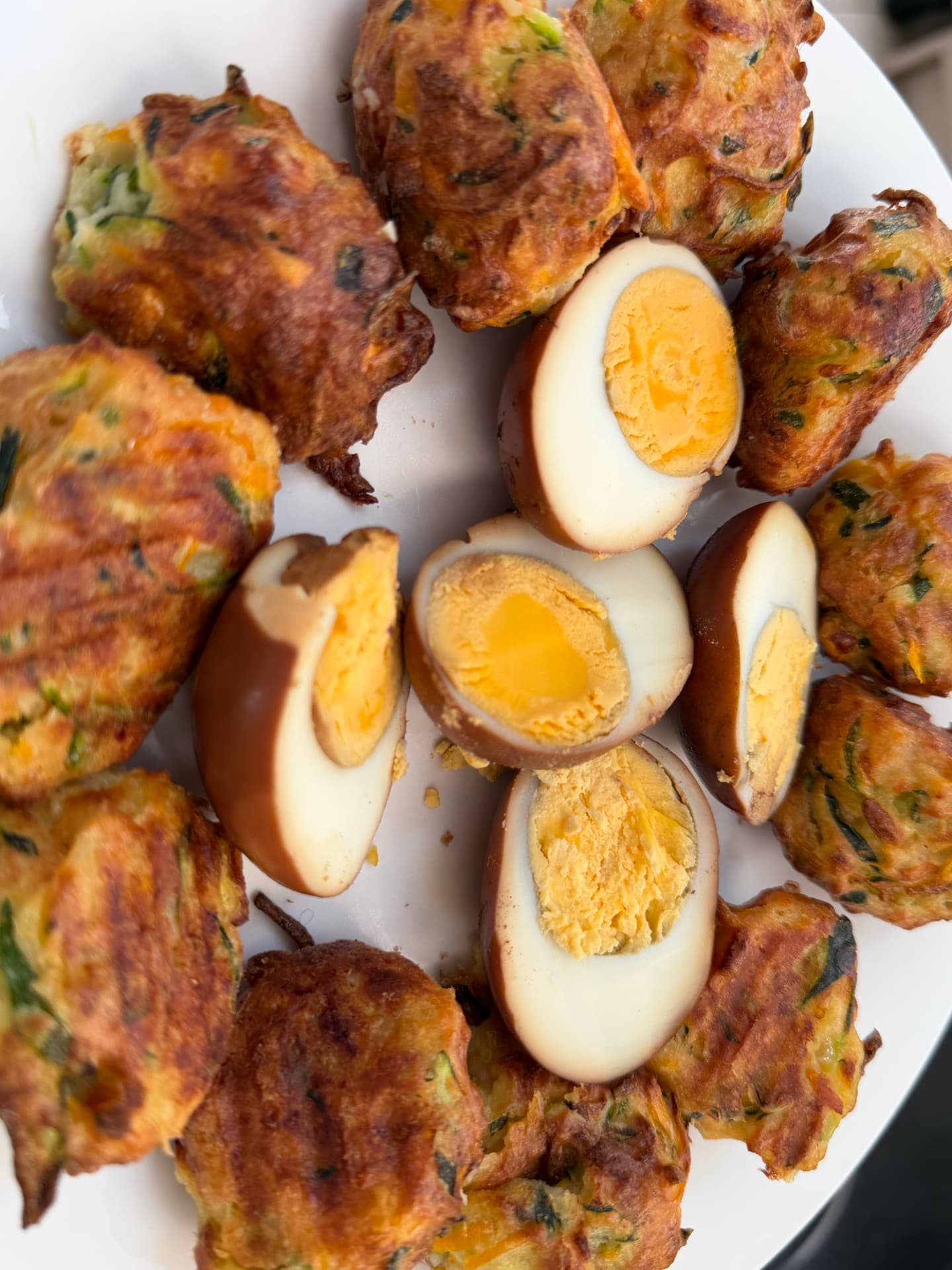 Zucchini and carrot fritters with soy-braised eggs