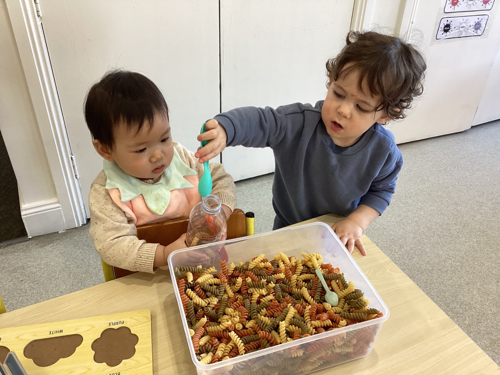 Sensory play with pasta and scoops