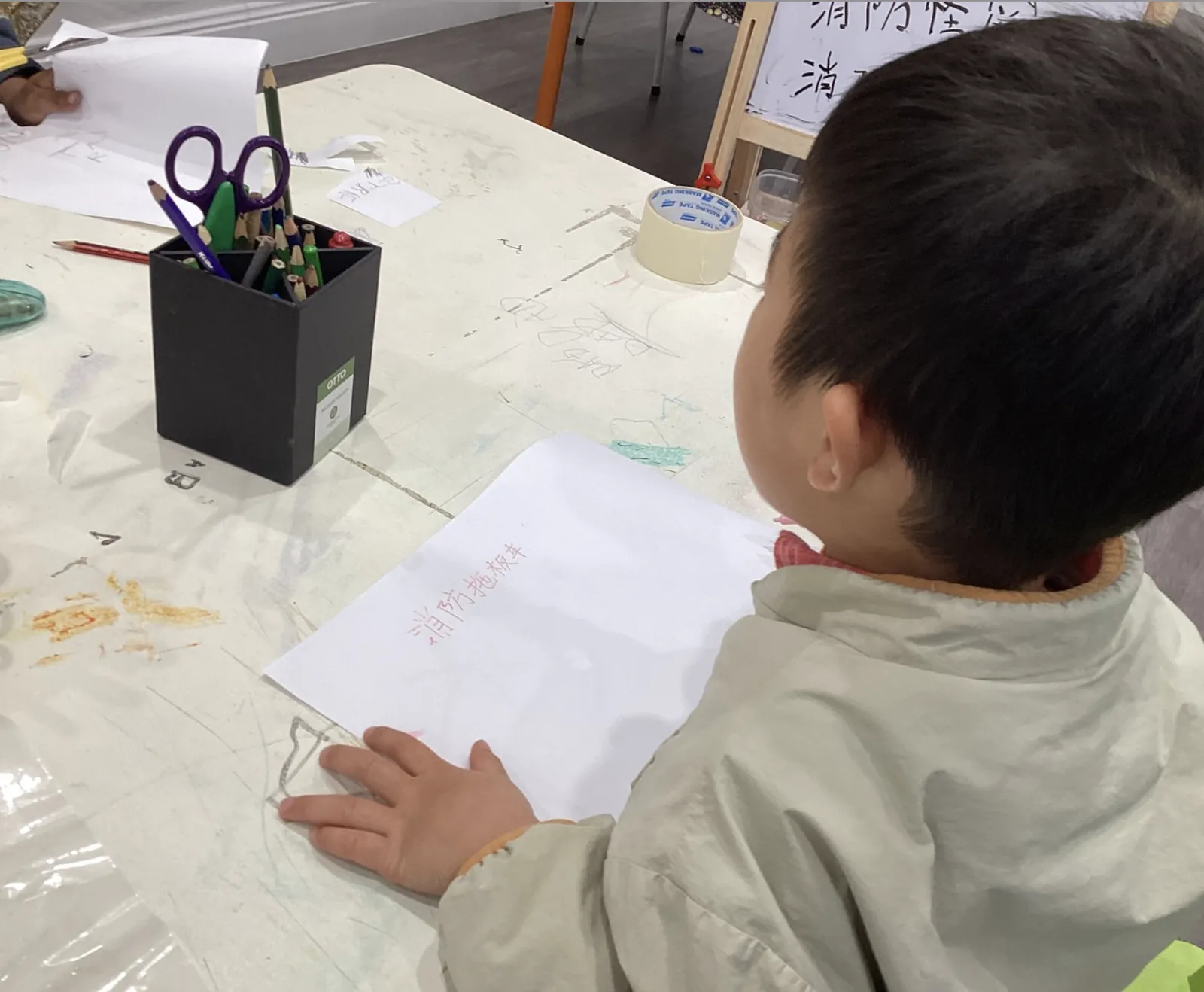 Child practising writing Chinese characters during the language programme