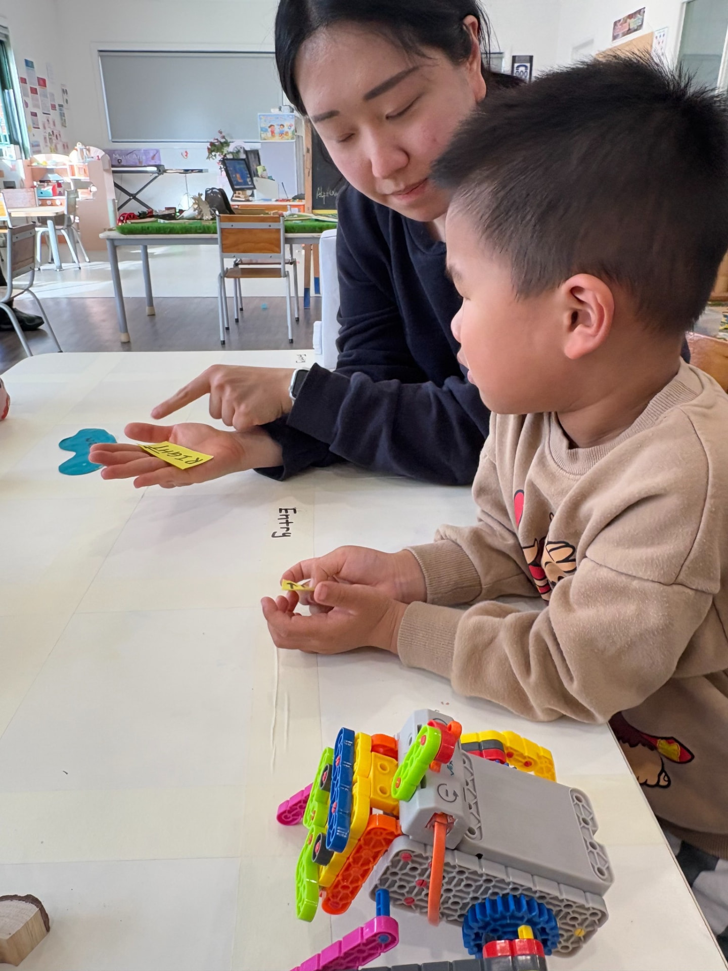 One-on-one guidance — reading direction cards with an educator